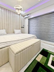 a bedroom with two beds and a window at Domina Apartment in Kubwa +18 photos