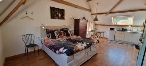 a bedroom with a bed and a kitchen at Hoeve Ruimzicht Renesse in Renesse