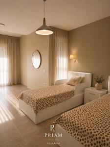 a bedroom with two beds and a round mirror at Valamar Priam Villa D11 in Hamallë