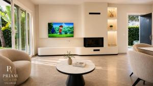 a living room with a tv on a wall at Valamar Priam Villa D11 in Hamallë
