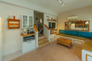 a living room with a blue couch and a table at HENNA VILLA in Fethiye