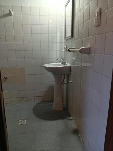 a bathroom with a sink and a mirror at HOSPEDAJE LA CASONA DE CACHI in Cachí