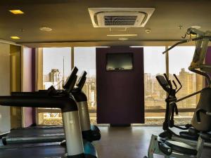 a gym with two exercise bikes and a television at VM Flats Guarulhos Aeroporto in Guarulhos +2 photos