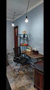 a room with a table and a black chair at Leipoldt street 3 in Clanwilliam