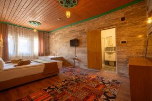 a large room with a bed and a tv in it at Arton İn Cappadocia in Göreme