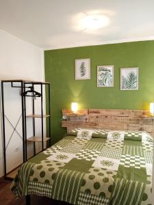 a bedroom with a large bed with green walls at Podere il Gallo Agriturismo in Campiglia Marittima