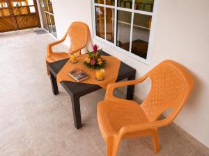 two chairs and a table with flowers on it at Cocoloco's Lodge in El Valle +54 photos