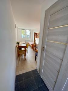 a door leading to a room with a table and a dining room at LKS Charzykowy 4 in Charzykowy