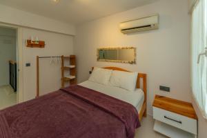 a small bedroom with a bed and a mirror at HENNA VILLA in Fethiye +18 photos