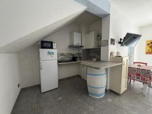 a kitchen with a refrigerator and a counter in a room at Al Baglio di Sant'Elia in Santa Flavia
