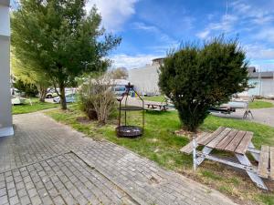 a park with a swing and a bench and trees at LKS Charzykowy 4 in Charzykowy