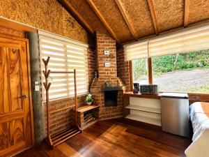 ein Zimmer mit Kamin und einer Backsteinwand in der Unterkunft Munay Wasi by Hospedaje Puntzán in Baños