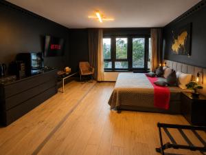 a bedroom with a bed and a television in it at La Suite Hotel - Self Check-in in Hanau am Main