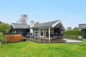 a house with a large deck in the yard at 30040-Beder-Hogevaenget-27 in Beder