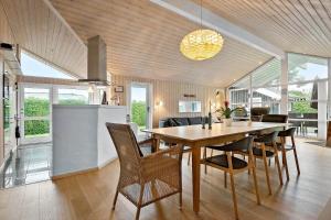 a kitchen and dining room with a table and chairs at 30040-Beder-Hogevaenget-27 in Beder