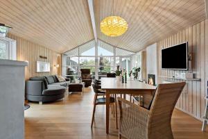 a living room with a table and a couch and a tv at 30040-Beder-Hogevaenget-27 in Beder