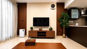 a living room with a flat screen tv at Beachfront Apartment with Pool & Stunning View in Salalah