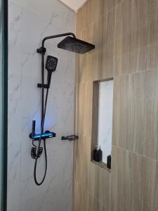 a shower with a shower head in a bathroom at Premium 21 Suites in La Paz +27 photos