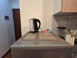 a coffee maker sitting on top of a counter at Premium 21 Suites in La Paz