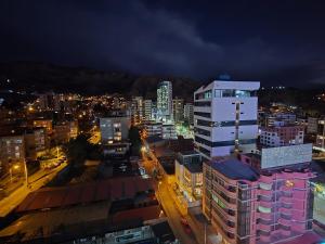 a view of a city at night with buildings at Premium 21 Suites in La Paz