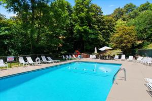 a large swimming pool with chairs at 1023 English Mtn Condo by Beyond Expectations in Sevierville