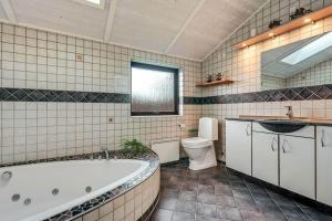 a bathroom with a tub and a toilet and a sink at C11761-Hemmet-Sydmarken-27 in Falen +40 photos
