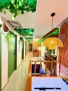 a lobby with green walls and a ceiling with a chandelier at Hotel EcoStay at Chow kit in Kuala Lumpur