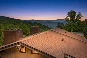 a roof of a house with mountains in the background at 1023 English Mtn Condo by Beyond Expectations in Sevierville