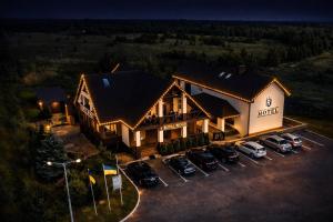 an aerial view of a house with cars parked in a parking lot at Royal Wood Hotel in Rokytne