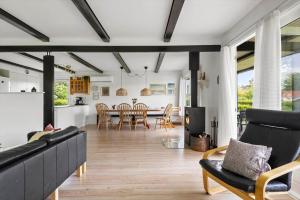 a living room with a table and a dining room at 40583-Juelsminde-Pot-Strandby-119 in Sønderby