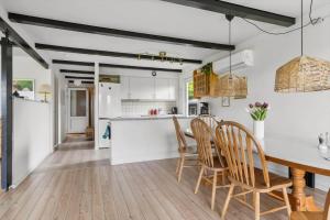 a kitchen and dining room with a table and chairs at 40583-Juelsminde-Pot-Strandby-119 in Sønderby +16 photos