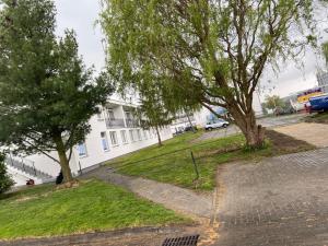 a street with two trees in front of a building at LKS Charzykowy 4 in Charzykowy +2 photos