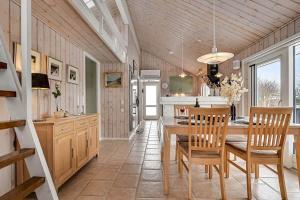 a kitchen and dining room with a table and chairs at C11266-Hemmet-Egernvej-10 in Hemmet