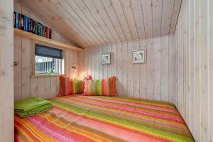 a bedroom with a large bed in a small room at C11266-Hemmet-Egernvej-10 in Hemmet