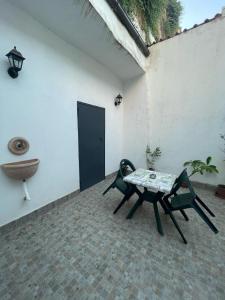 a patio with a table and a bench and a sink at Case vacanza Controvento in Palermo