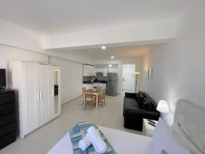 a living room with a couch and a table at AVENTURA SUITES playa LOS CORALES - great location! in Punta Cana +21 photos