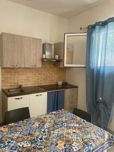 a kitchen with a table and a blue curtain at Case vacanza Controvento in Palermo +12 photos