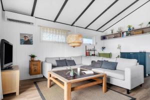 a living room with a couch and a coffee table at 40322-Juelsminde-Frede-Juels-vej-261 in Sønderby