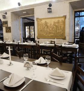 a dining room with tables and chairs with white napkins at Hotel Santa Rosa in Arequipa