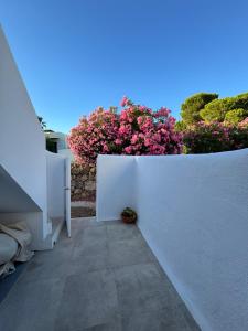 a white fence with pink flowers in a garden at Villa Valentina-Sunny 2 Bedroom House with Pool in Carvoeiro