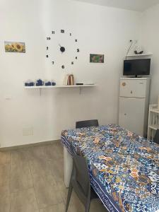 a dining room with a table and a clock on the wall at Case vacanza Controvento in Palermo