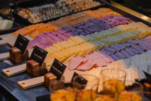 a bunch of different types of cheese on a table at Slaviero Hotel Baia Norte Florianópolis in Florianópolis +98 photos