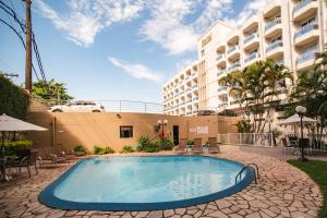 a swimming pool in front of a building at Slaviero Hotel Baia Norte Florianópolis in Florianópolis