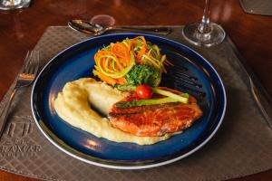 a blue plate of food with meat and vegetables at Slaviero Hotel Baia Norte Florianópolis in Florianópolis