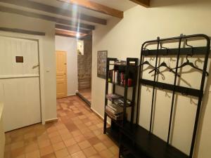 a room with a bed and a book shelf at Gîte de la Garriguette in Rasteau