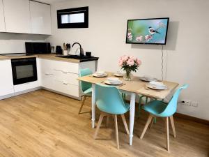 a kitchen and dining room with a table and chairs at Au Charme De Bussy - Maison proche Disney avec terrasse et parking in Bussy-Saint-Georges
