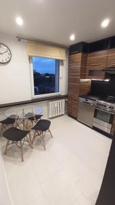a kitchen with a table and chairs and a window at Jura Horizon in Myszków