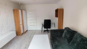 a living room with a couch and a desk at Jura Horizon in Myszków