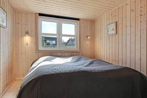 a bedroom with a bed in a room with a window at C11769-Hemmet-Vester-Faelled-14 in Falen
