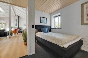 a bedroom with a large bed in a room at C11768-Hemmet-Klydevaenget-4 in Falen